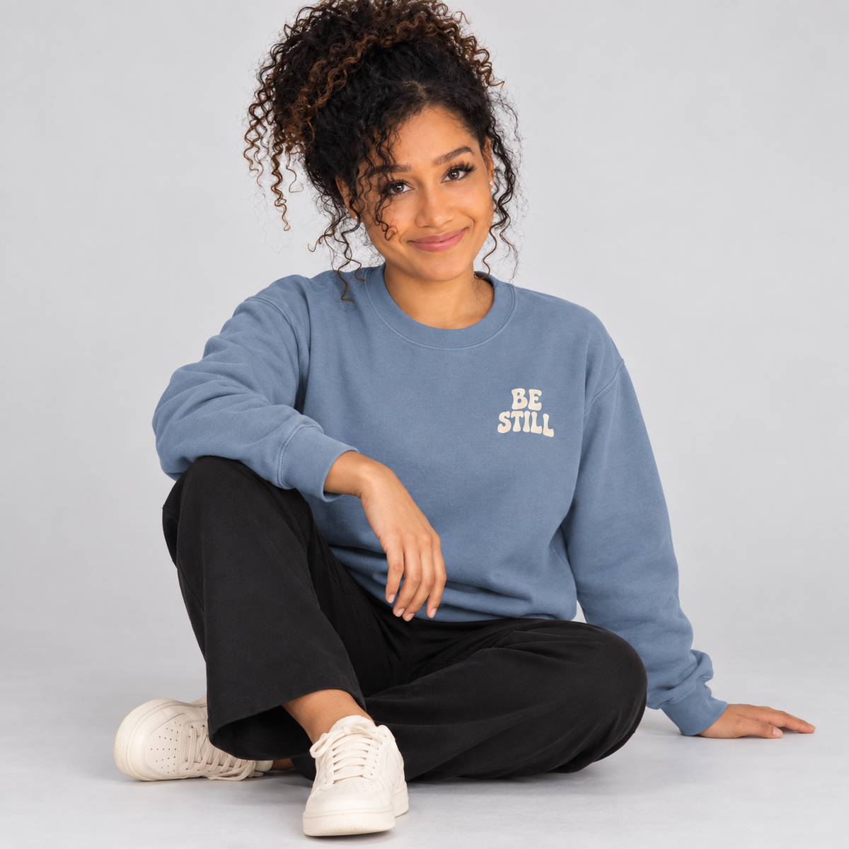 Be Still & Know Sweatshirt in Blue Jean — relaxed lifestyle pose.