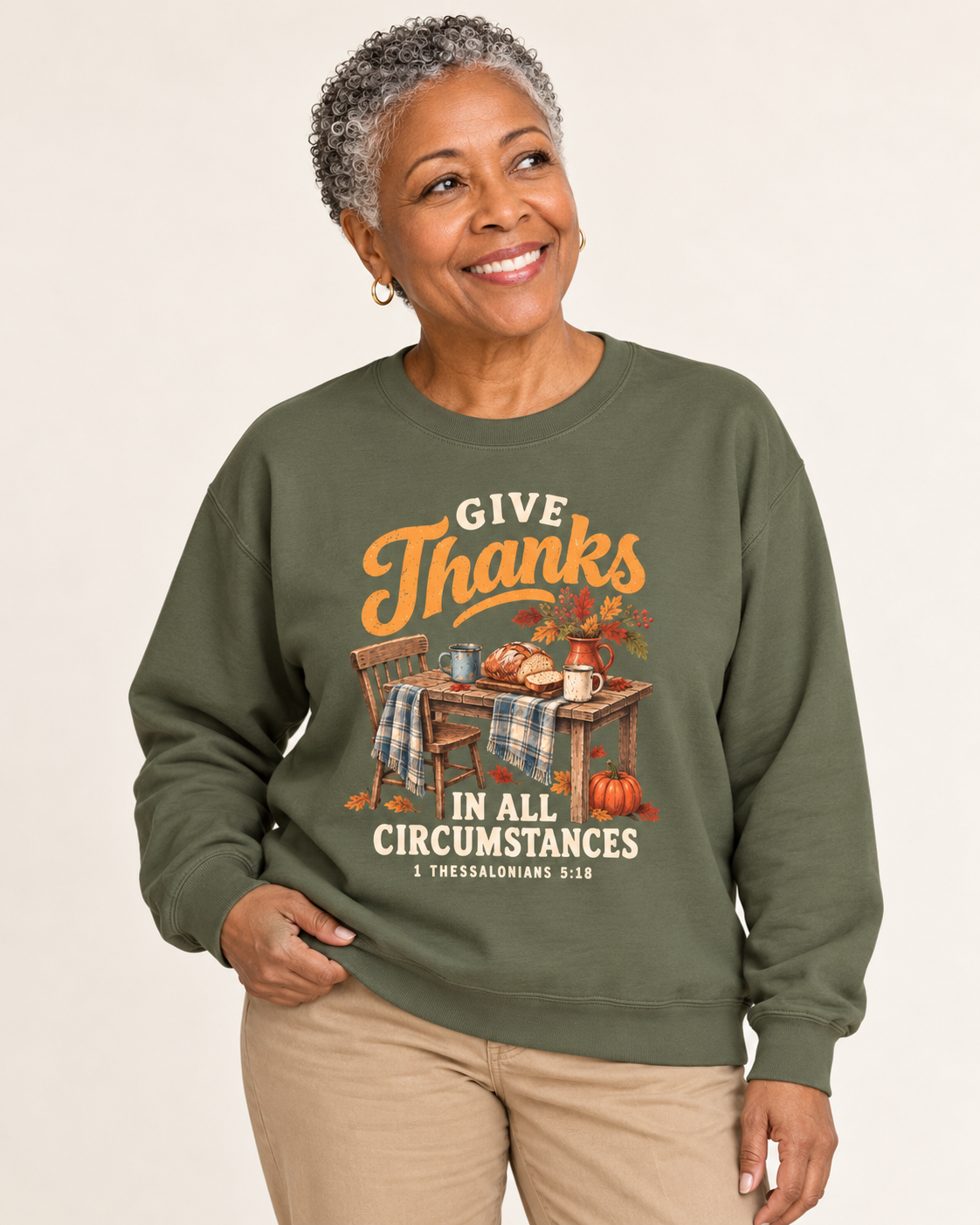 Give Thanks sweatshirt in Military Green — front design close-up on a model