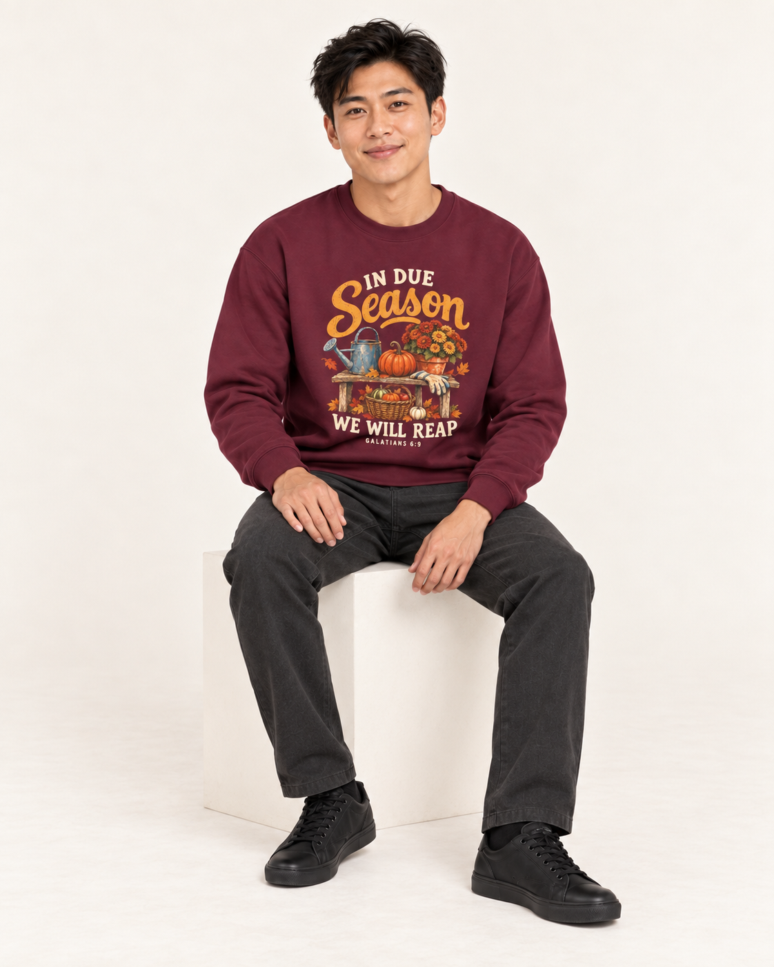 In Due Season sweatshirt in Maroon — seated on a model