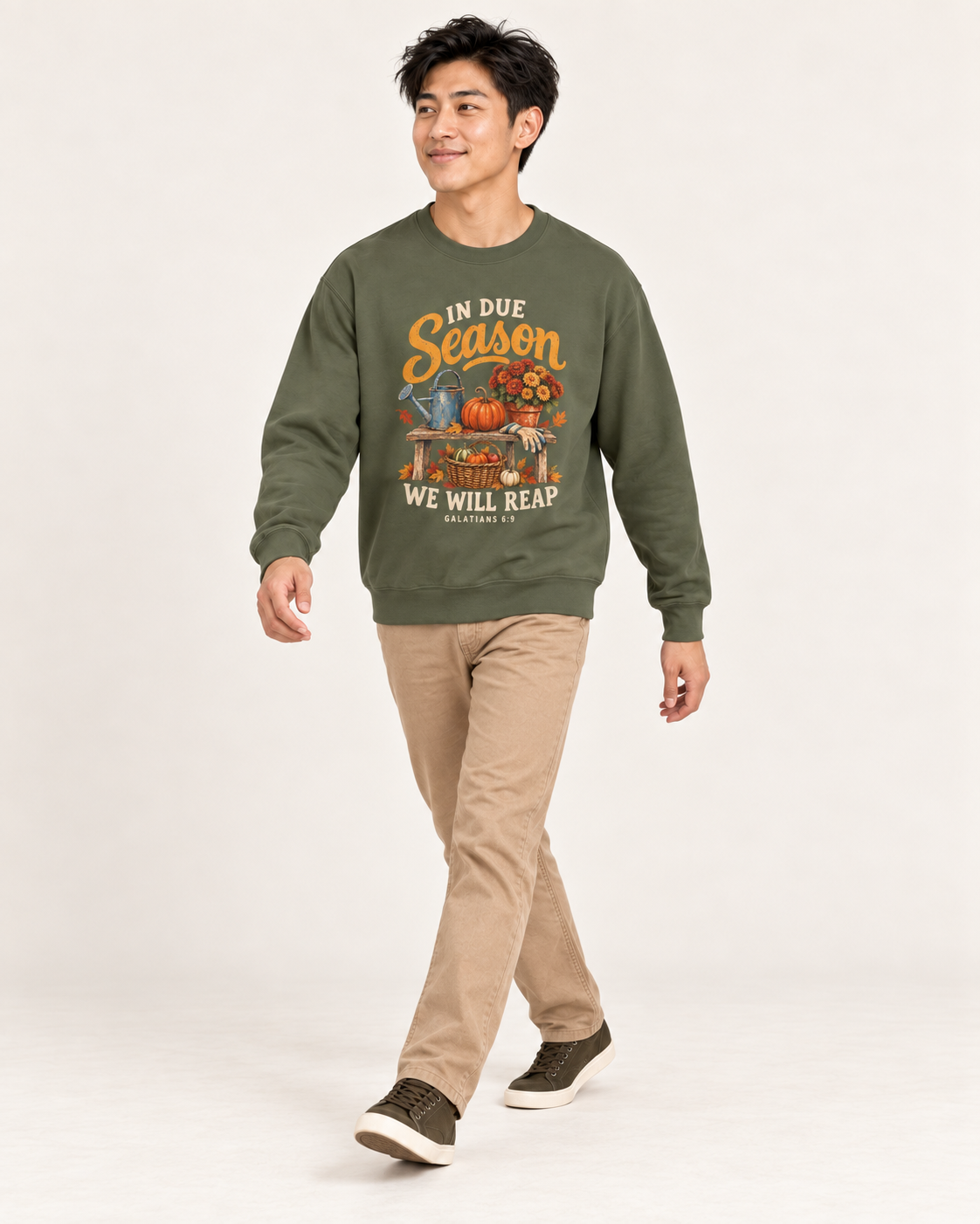 In Due Season sweatshirt in Military Green — walking on a model