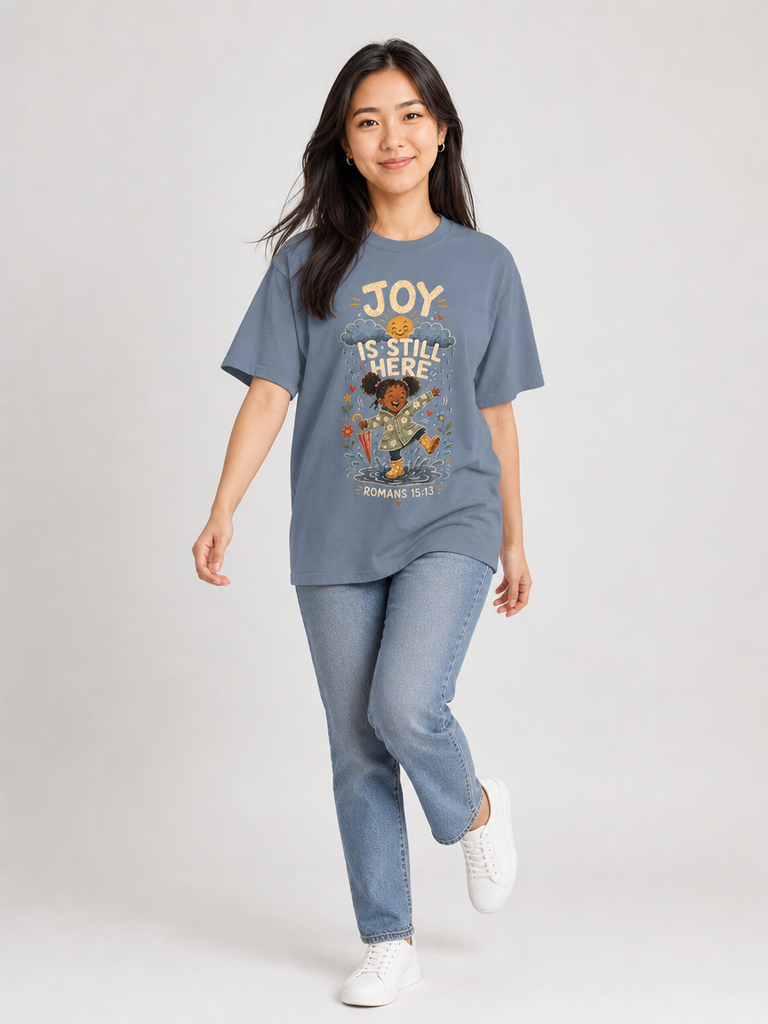 Joy Is Still Here Romans 15:13 Christian tee in Blue Jean, walking view