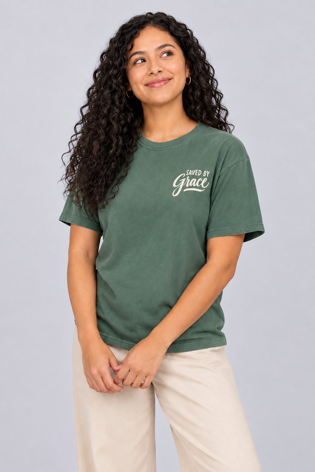 Woman wearing the Blue Spruce Saved by Grace Tee in a close looking-up pose.