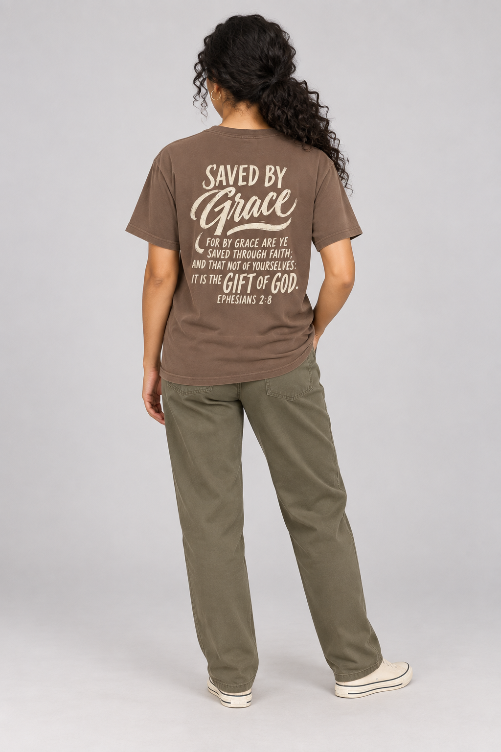 Woman wearing the Espresso Saved By Grace Tee in a full back pose.