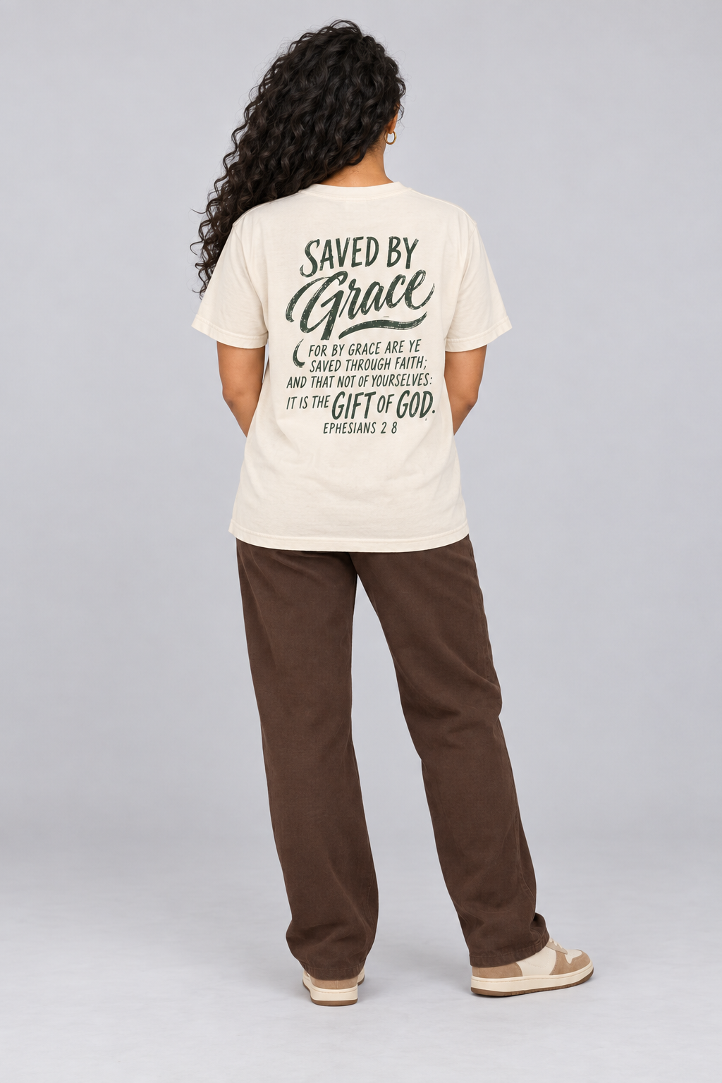 Woman wearing the Ivory Saved By Grace Tee in a full back pose.