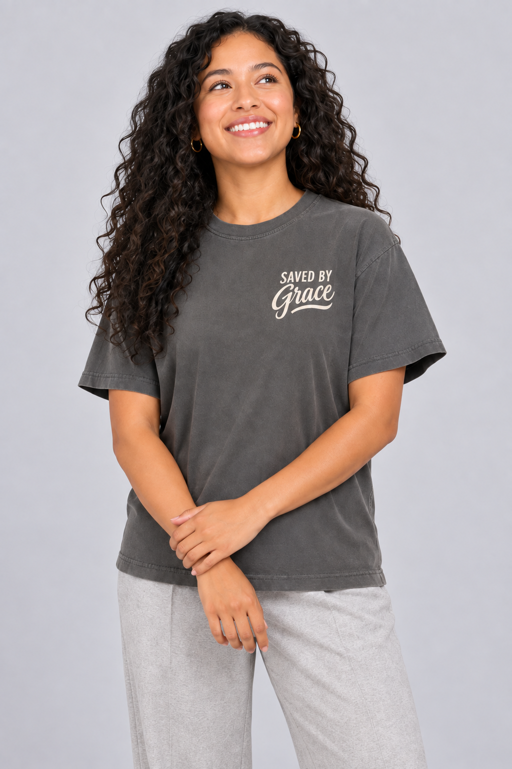 Woman wearing the Pepper Saved by Grace Tee in a close looking-up pose.