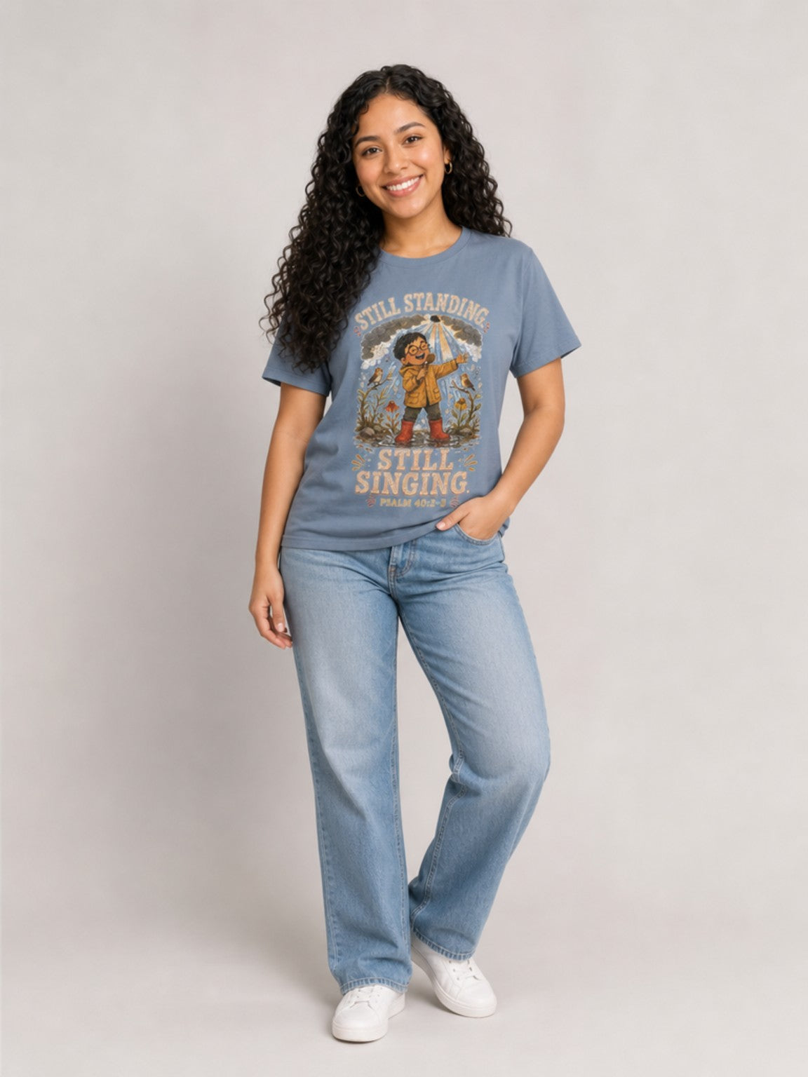 Still Standing, Still Singing Psalm 40:2-3 Comfort Colors tee in Blue Jean, standing view