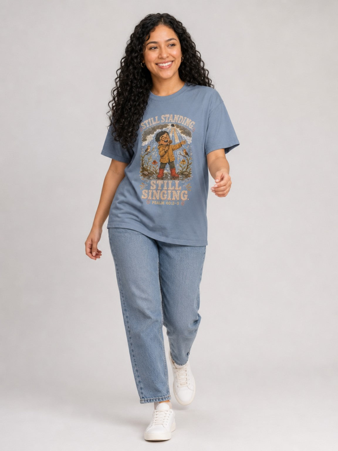 Still Standing, Still Singing Psalm 40:2-3 Comfort Colors tee in Blue Jean, walking view