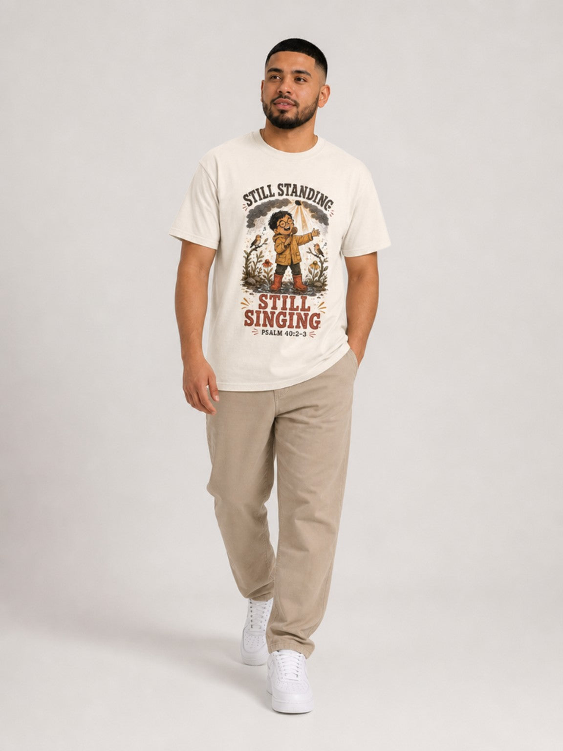 Still Standing, Still Singing Psalm 40:2-3 Comfort Colors tee in Ivory, walking view