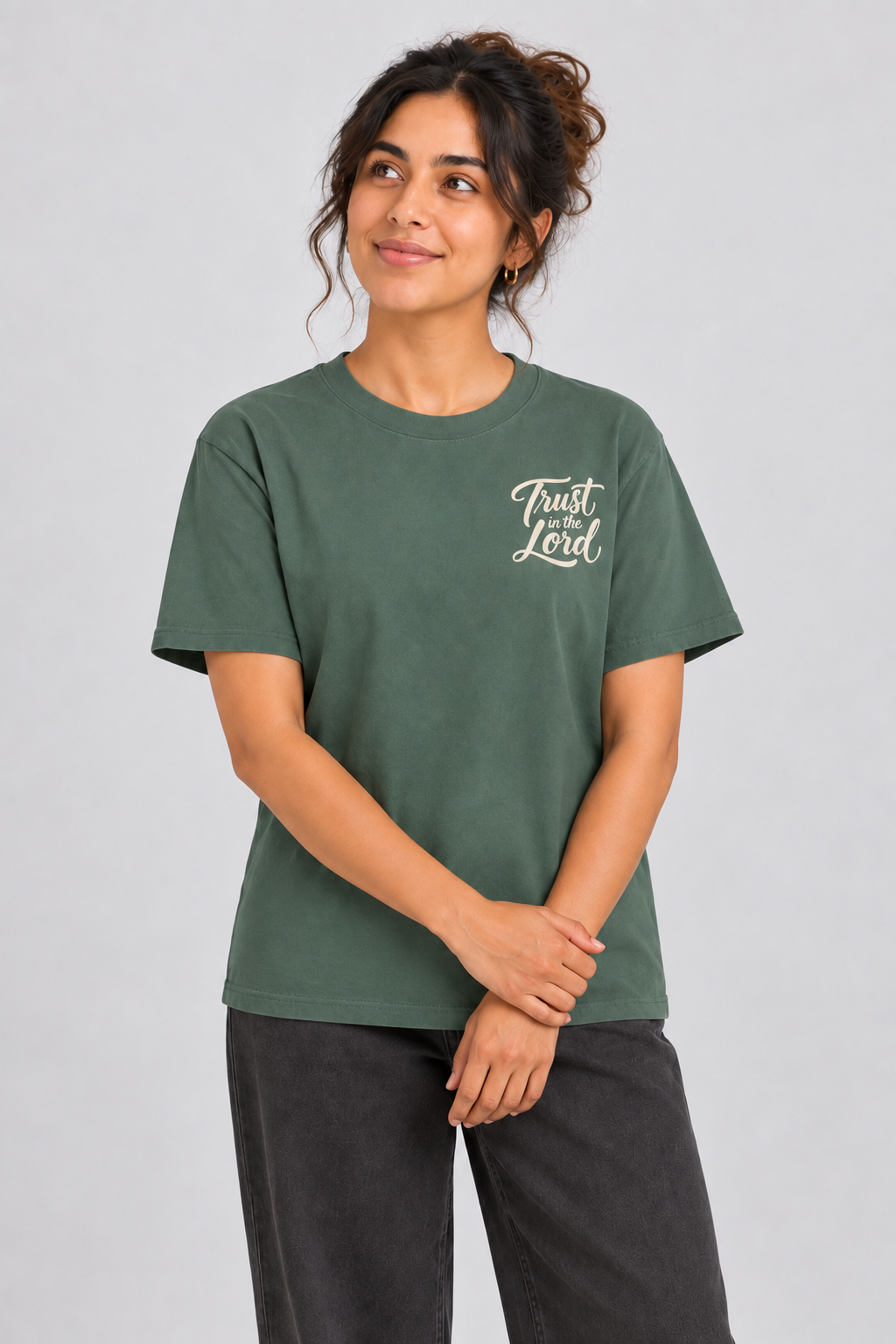Woman wearing the Blue Spruce Trust in the Lord Tee in a close looking-up pose.