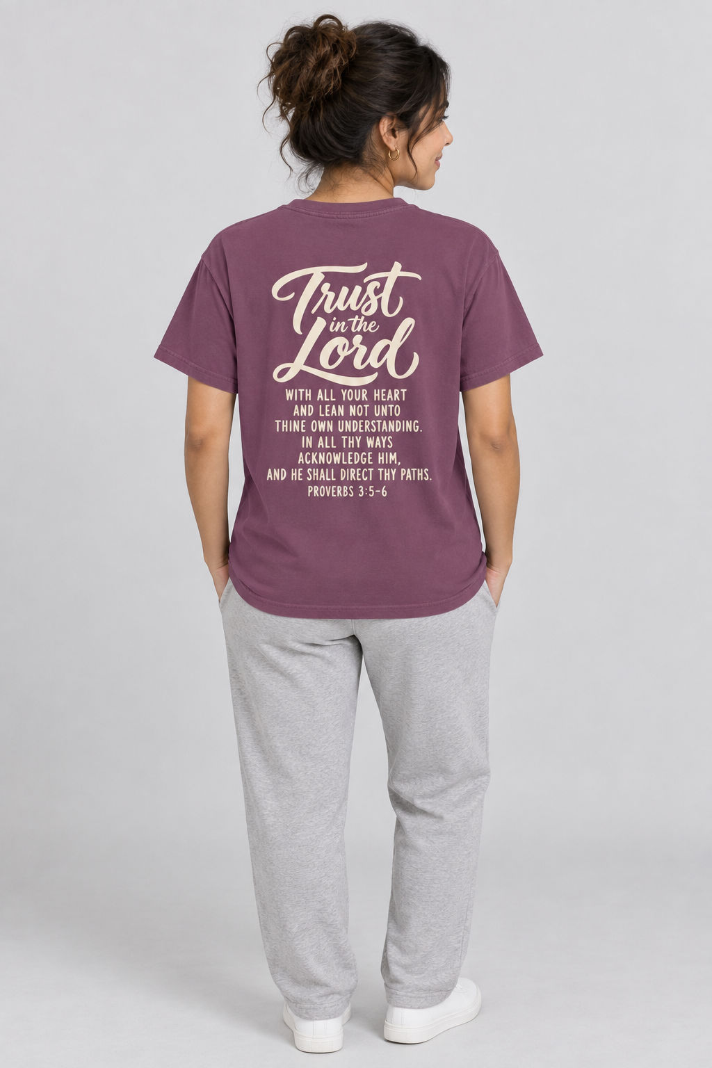 Woman wearing the Berry Trust In The Lord Tee in a full back pose.