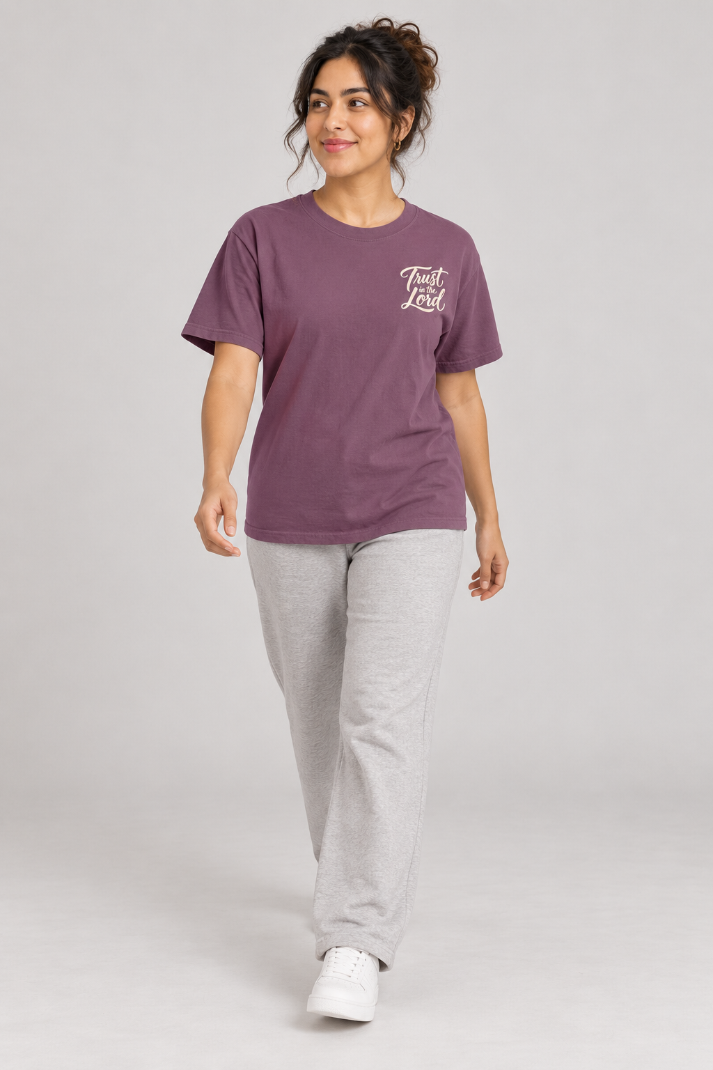 Woman wearing the Berry Trust In The Lord Tee in a walking pose.