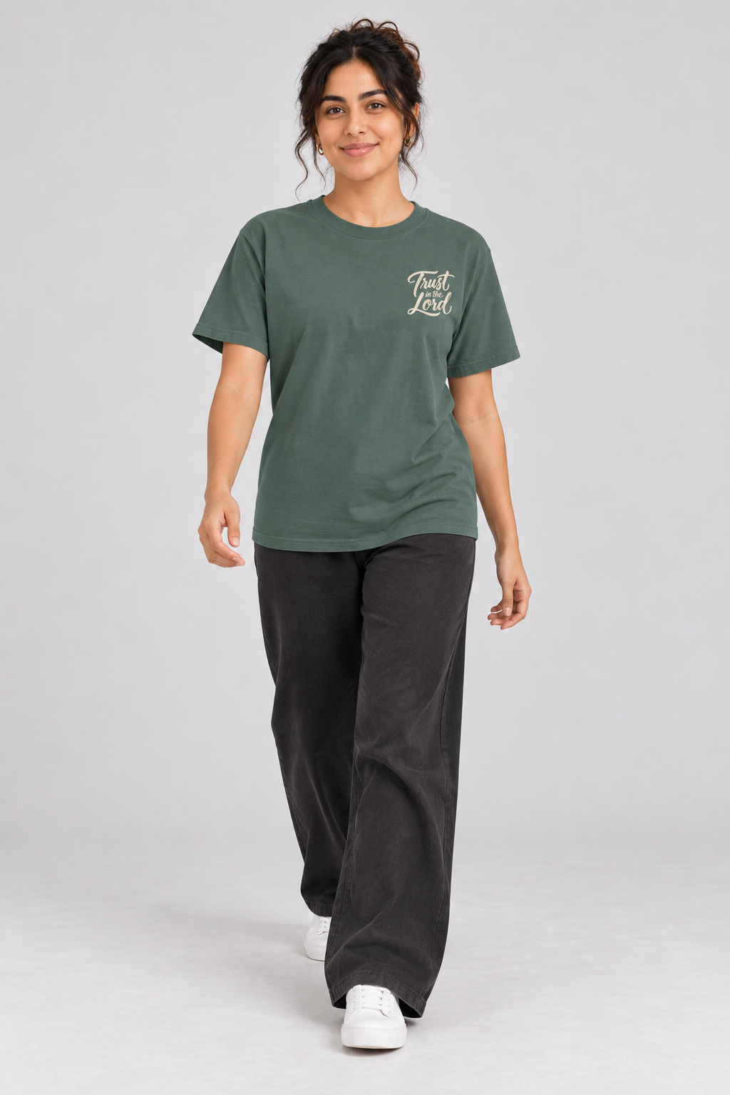 Woman wearing the Blue Spruce Trust In The Lord Tee in a walking pose.