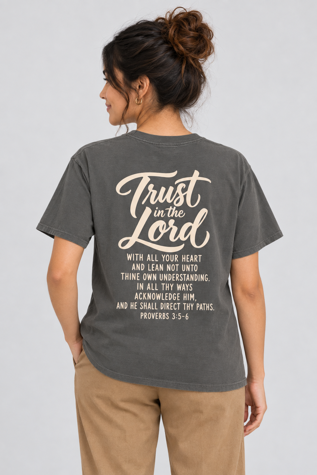 Woman wearing the Pepper Trust In The Lord Tee in a full back pose.