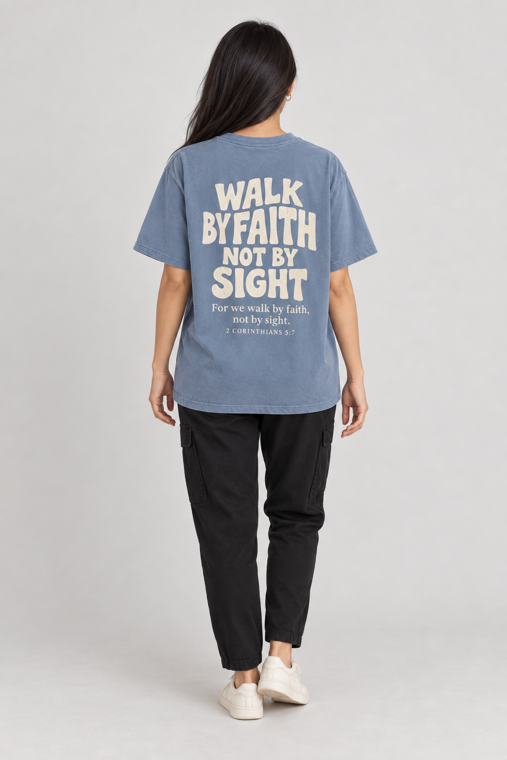 Woman wearing the Blue Jean Walk By Faith Tee in a full back pose.