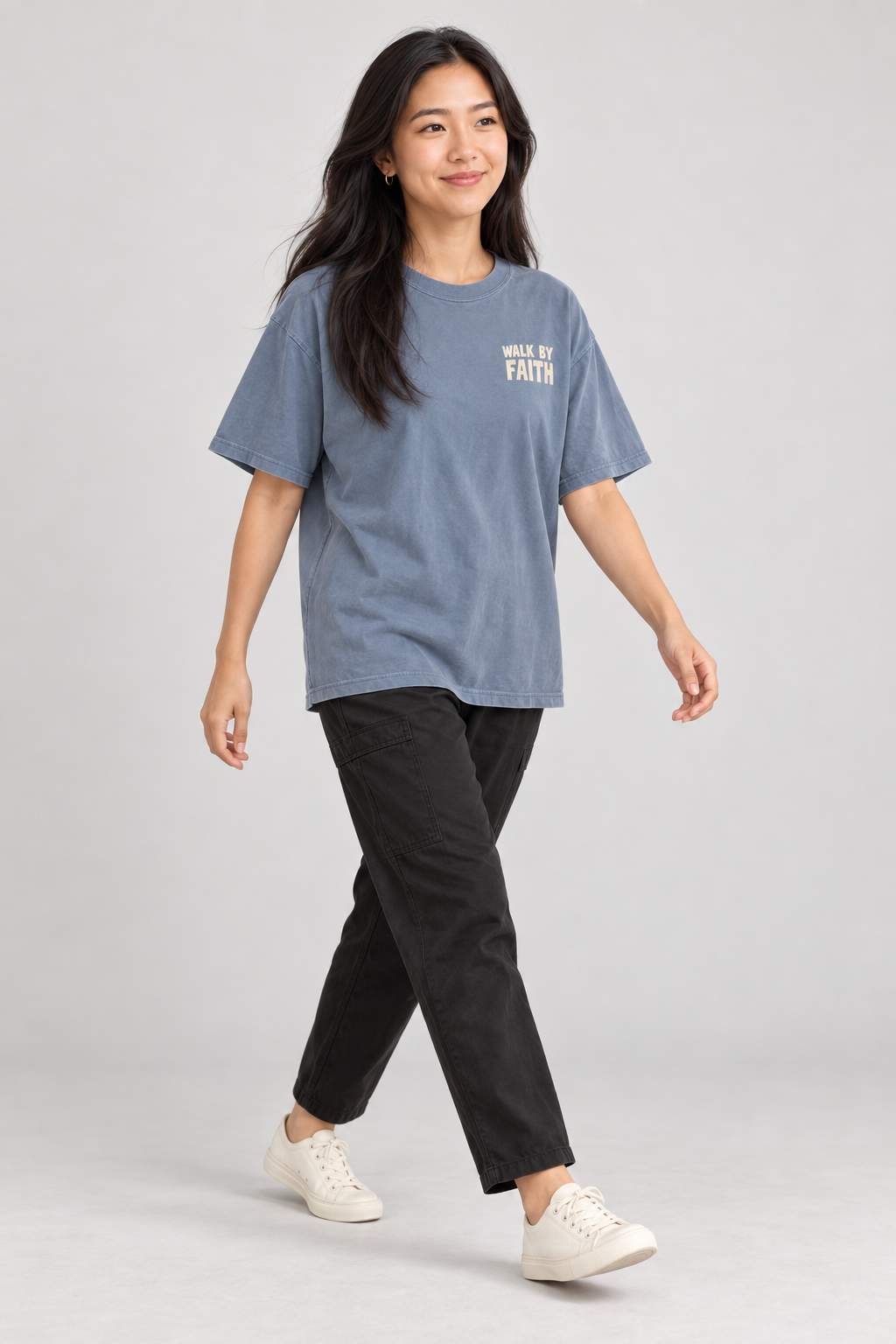 Woman wearing the Blue Jean Walk By Faith Tee in a walking pose.