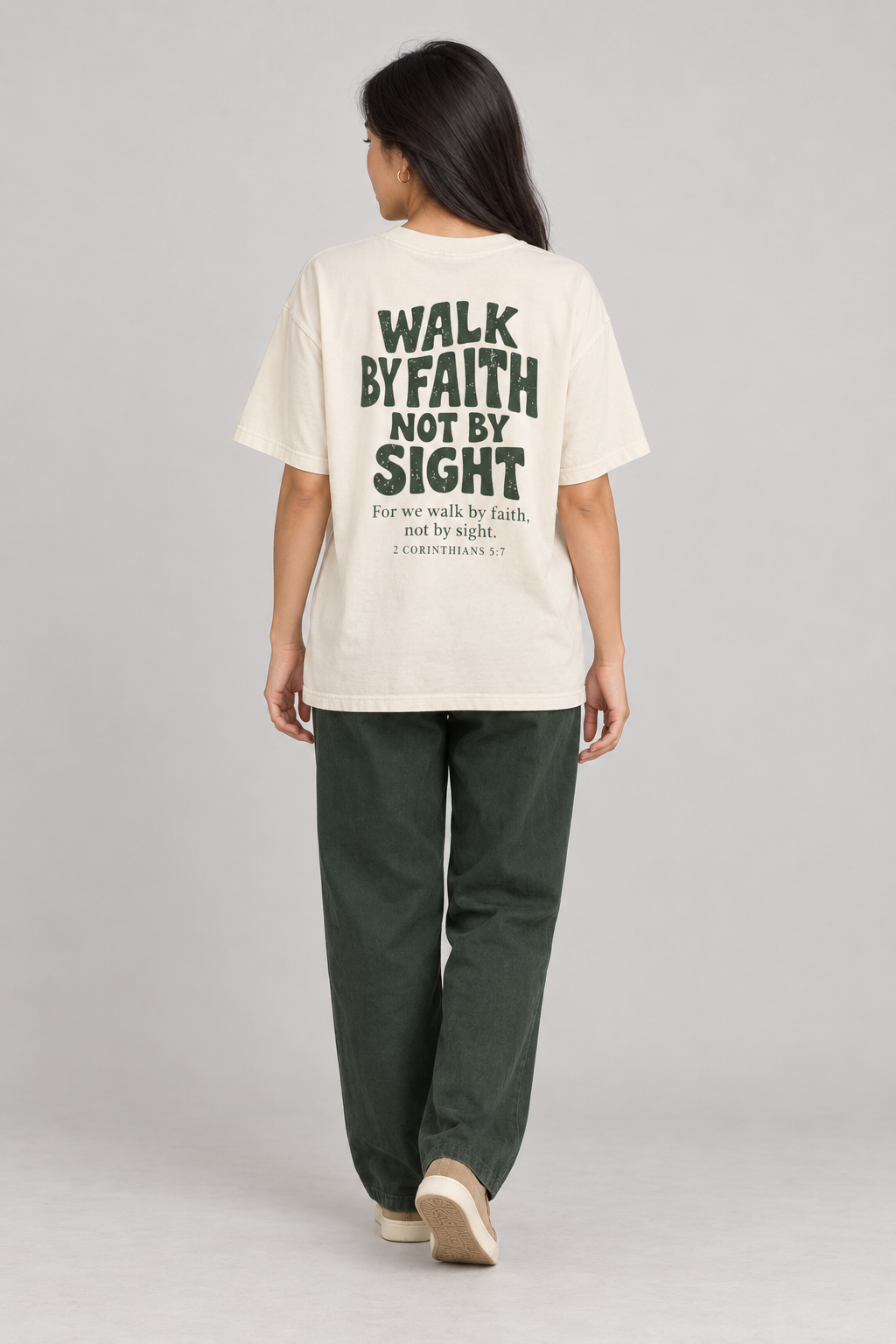 Woman wearing the Ivory Walk By Faith Tee in a full back pose.