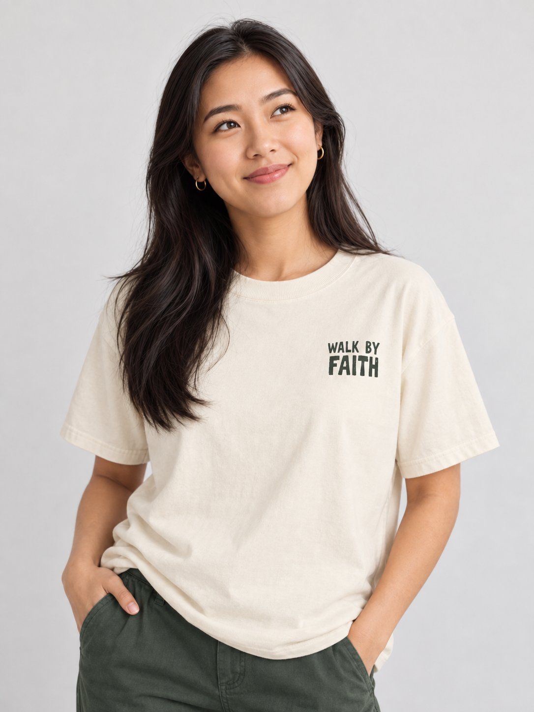 Woman wearing the Ivory Walk By Faith Tee in a looking up pose.