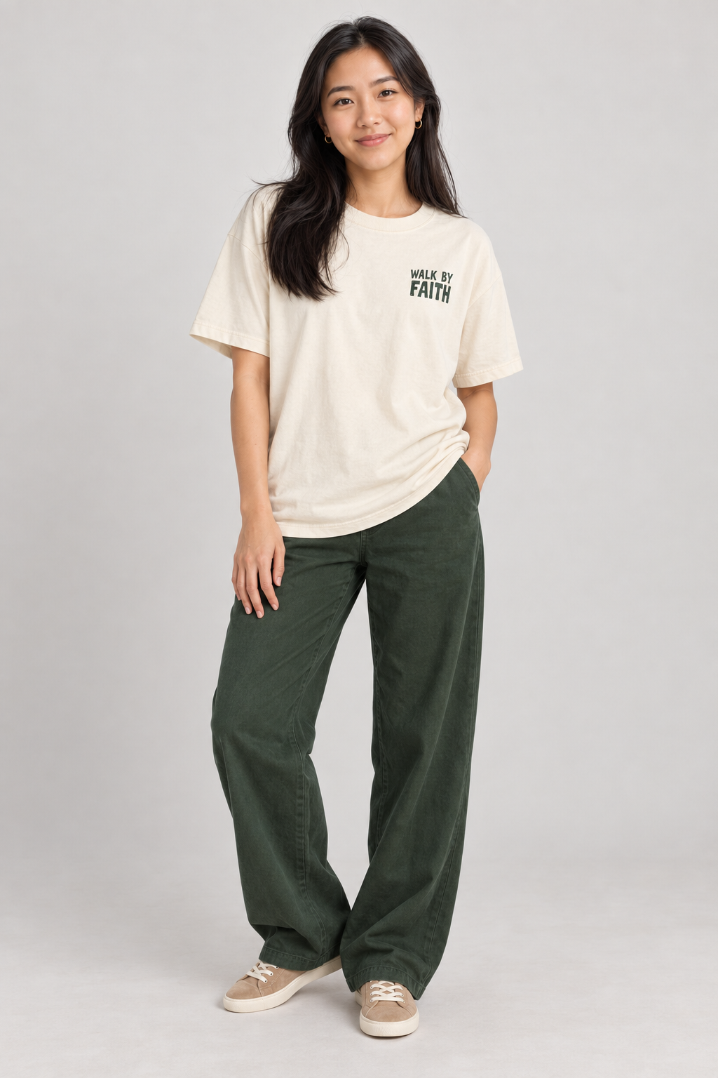 Woman wearing the Ivory Walk By Faith Tee in a standing pose.
