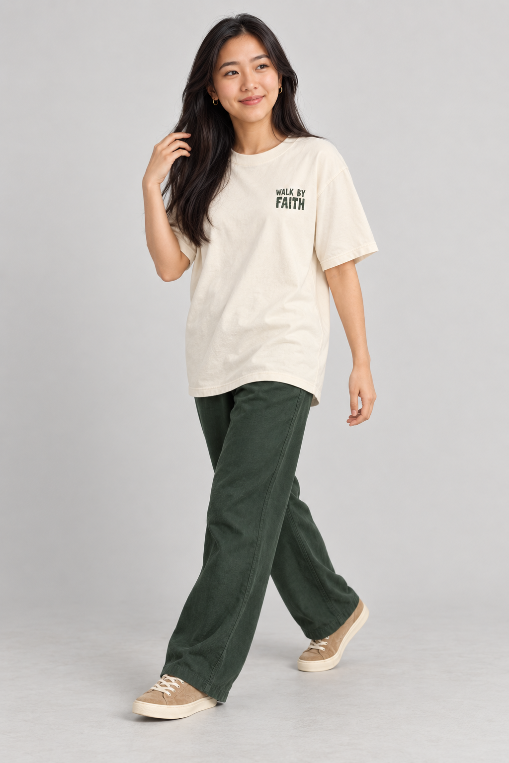 Woman wearing the Ivory Walk By Faith Tee in a walking pose.