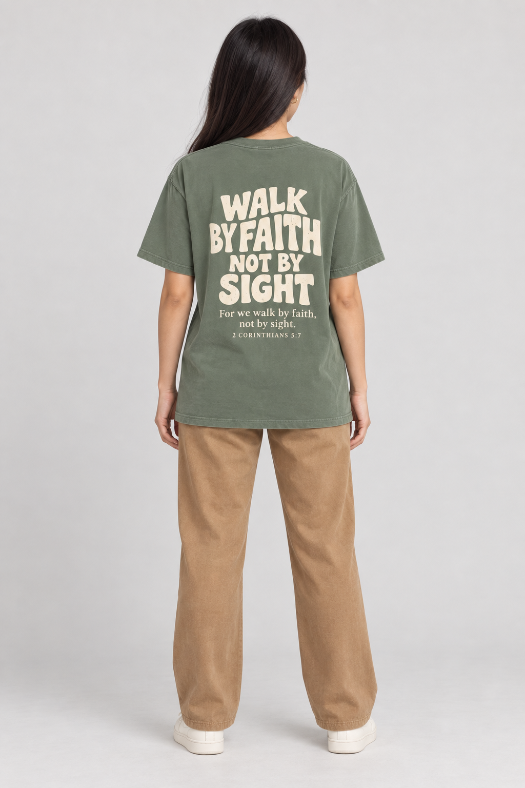 Woman wearing the Moss Walk By Faith Tee in a full back pose.