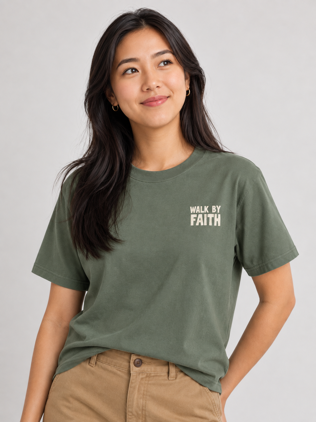 Woman wearing the Moss Walk By Faith Tee in a looking up pose.