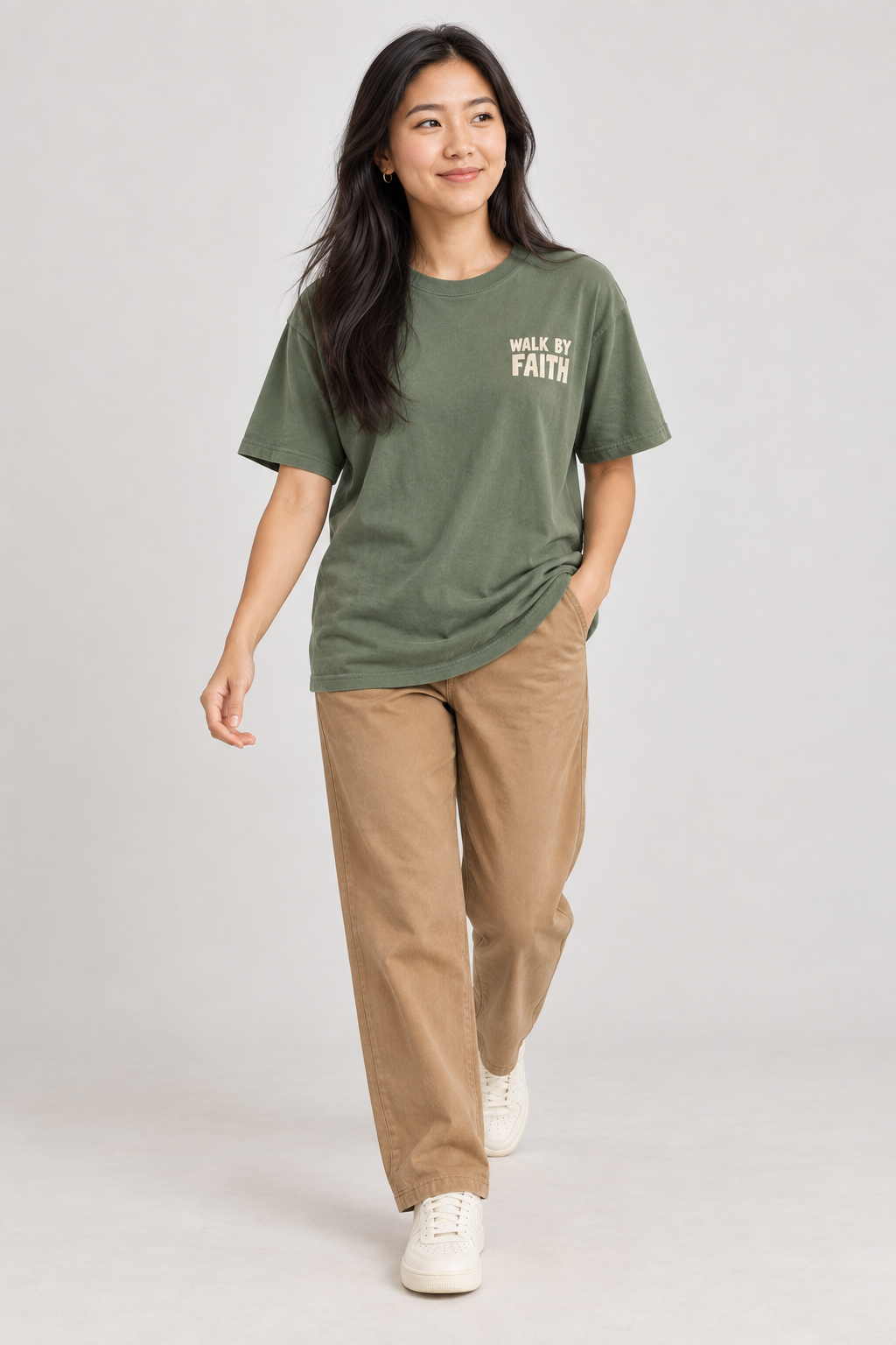 Woman wearing the Moss Walk By Faith Tee in a walking pose.