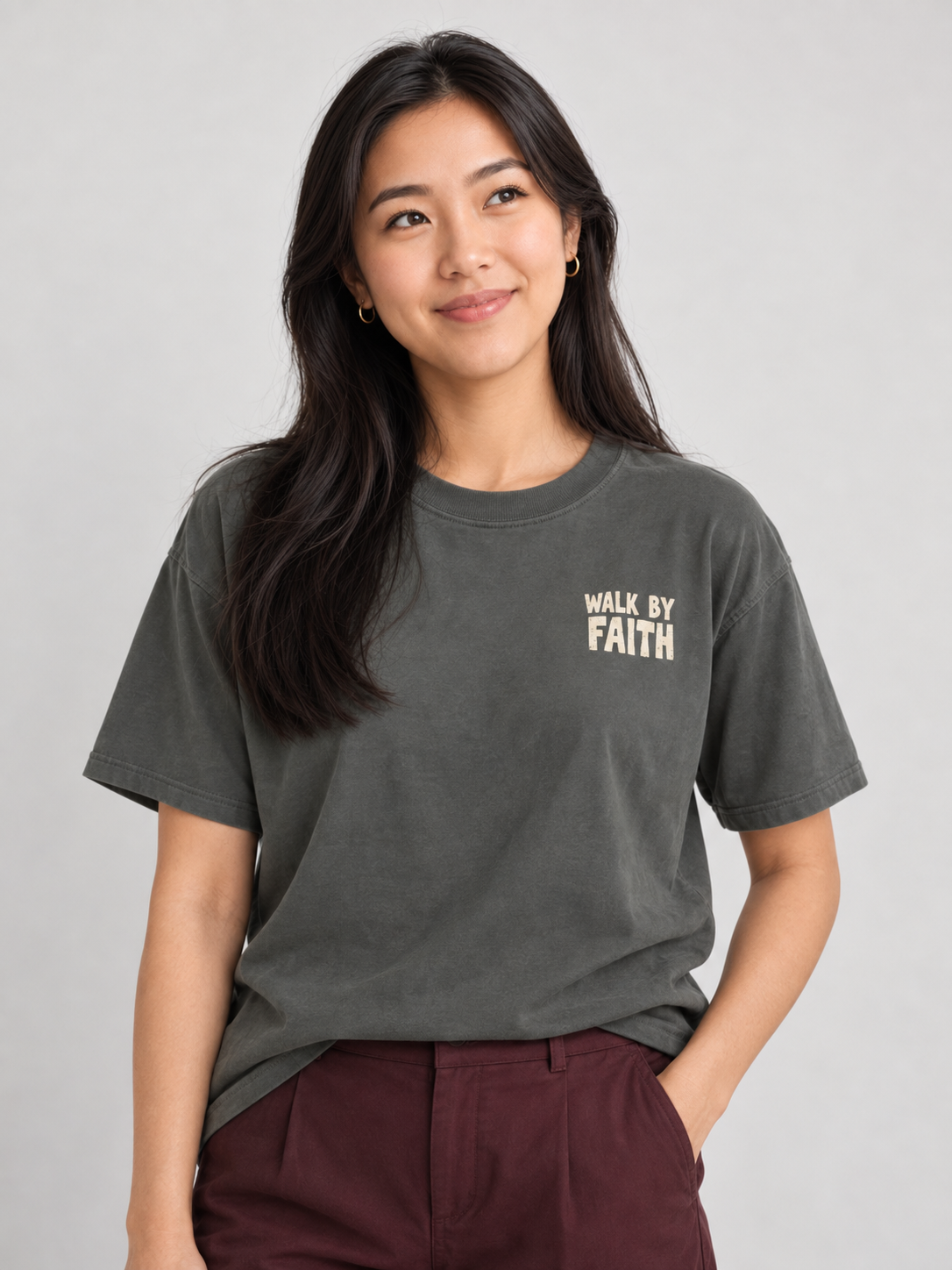 Woman wearing the Pepper Walk By Faith Tee in a looking up pose.