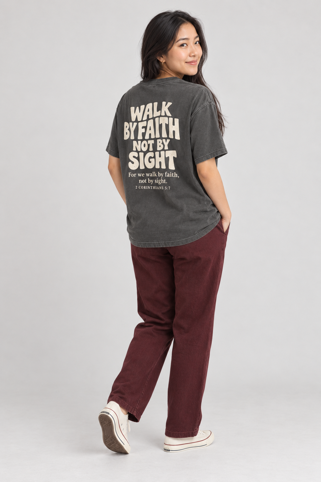 Woman wearing the Pepper Walk By Faith Tee in a shoulder-turn back pose.