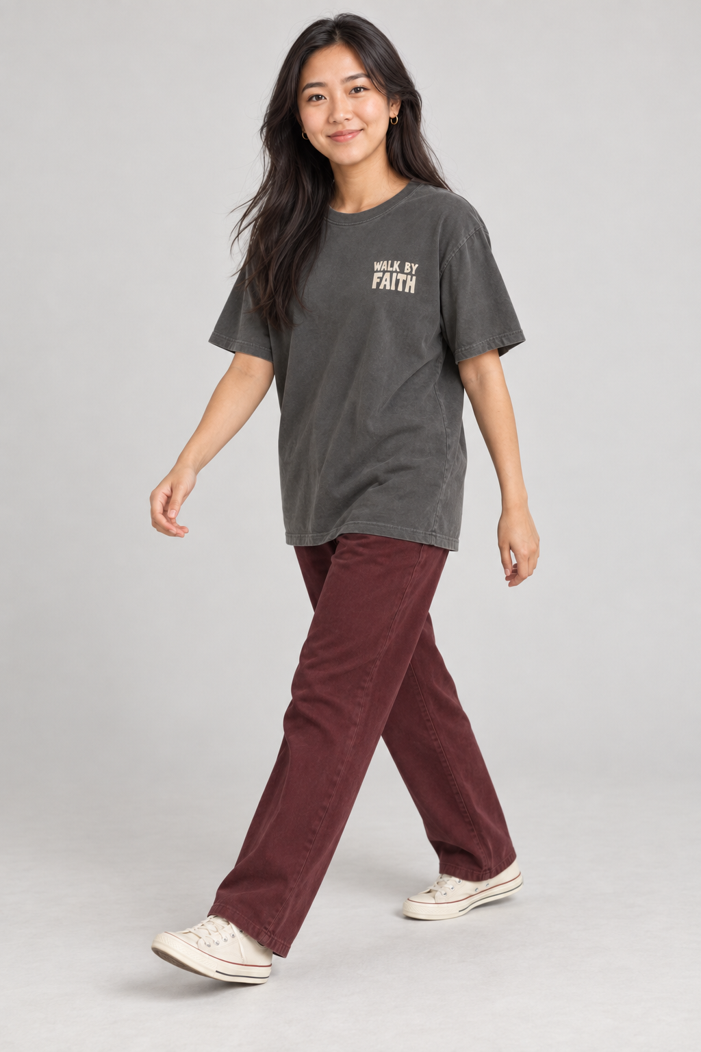 Woman wearing the Pepper Walk By Faith Tee in a walking pose.