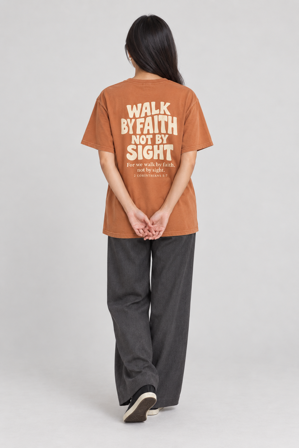 Woman wearing the Yam Walk By Faith Tee in a full back pose.
