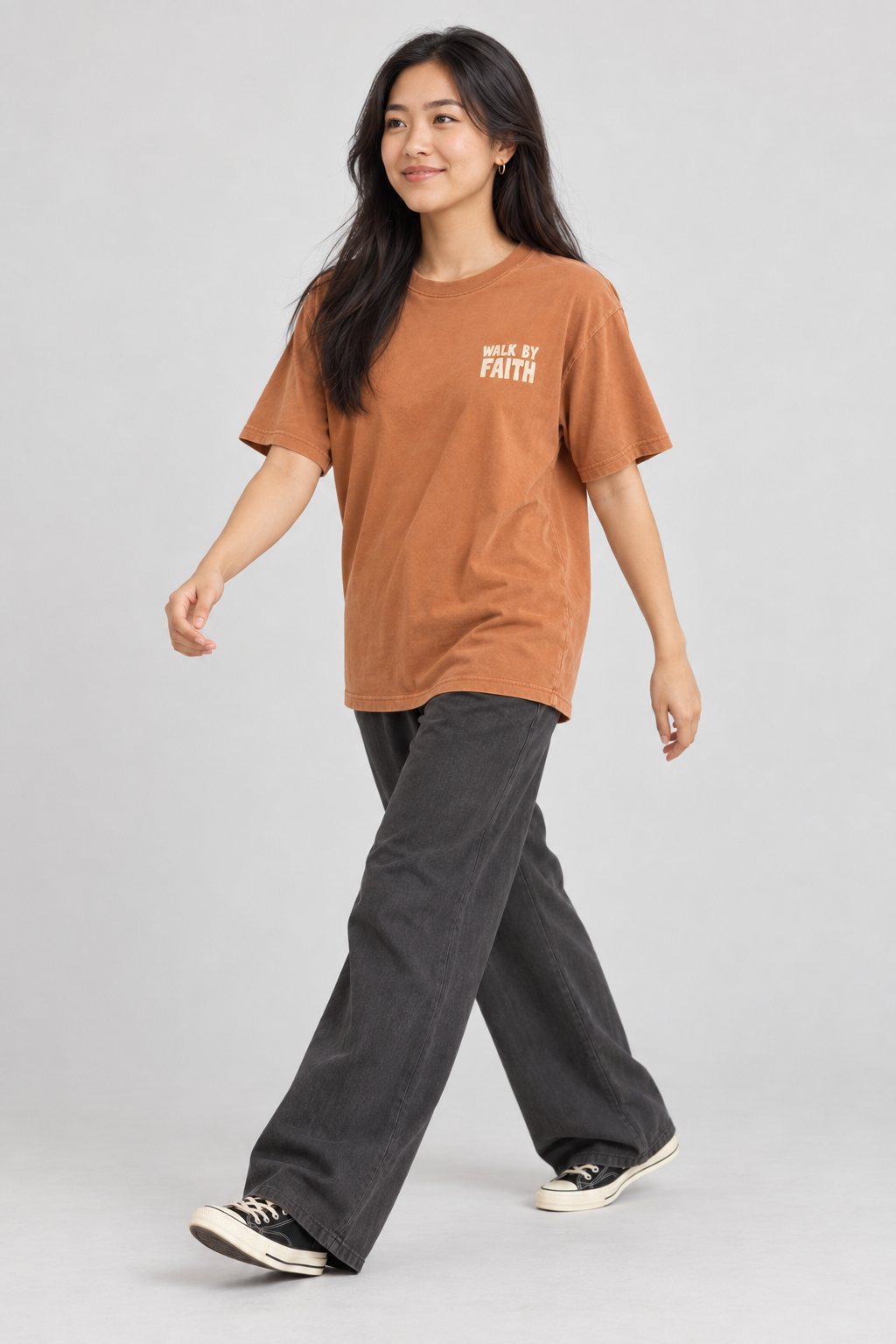 Woman wearing the Yam Walk By Faith Tee in a walking pose.