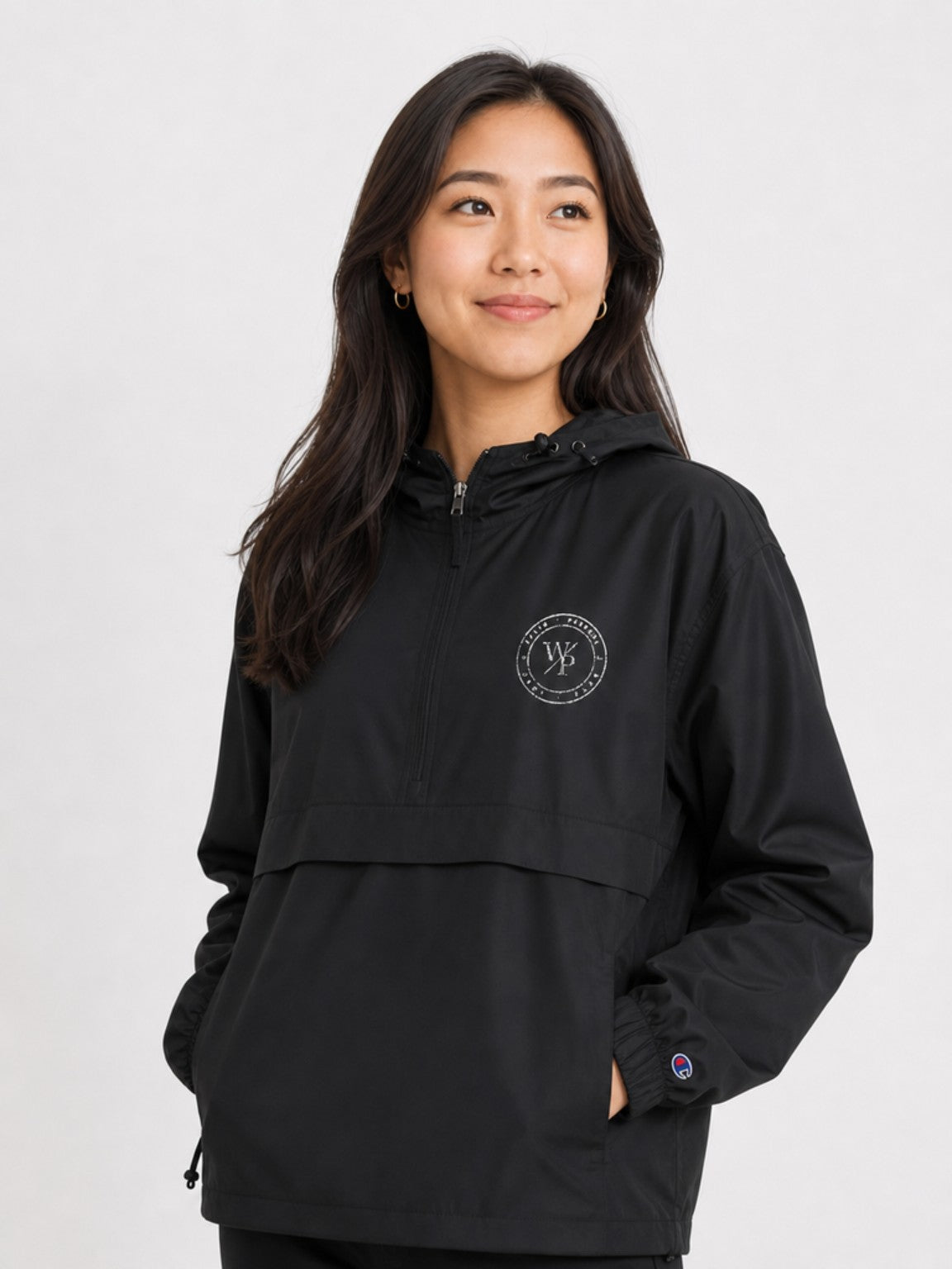 Black Worn with Purpose Champion packable anorak jacket, close-up of embroidered WP seal