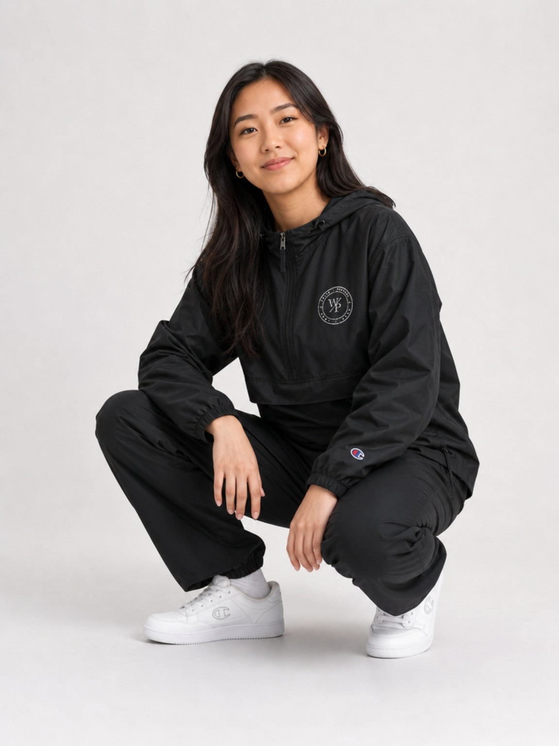 Woman styling the black Worn with Purpose Champion packable anorak jacket