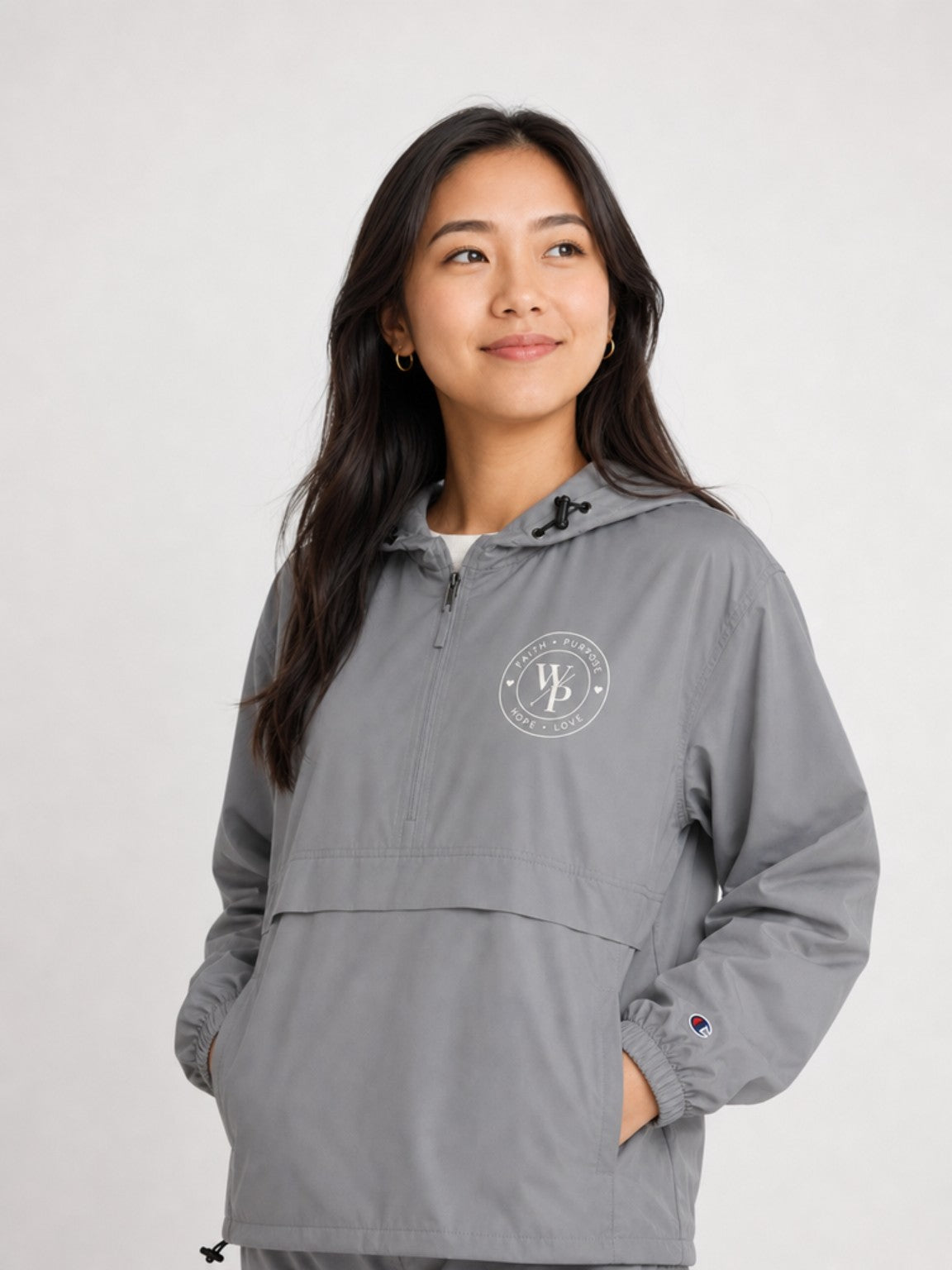 Graphite Worn with Purpose Champion packable anorak jacket, close-up of embroidered WP seal
