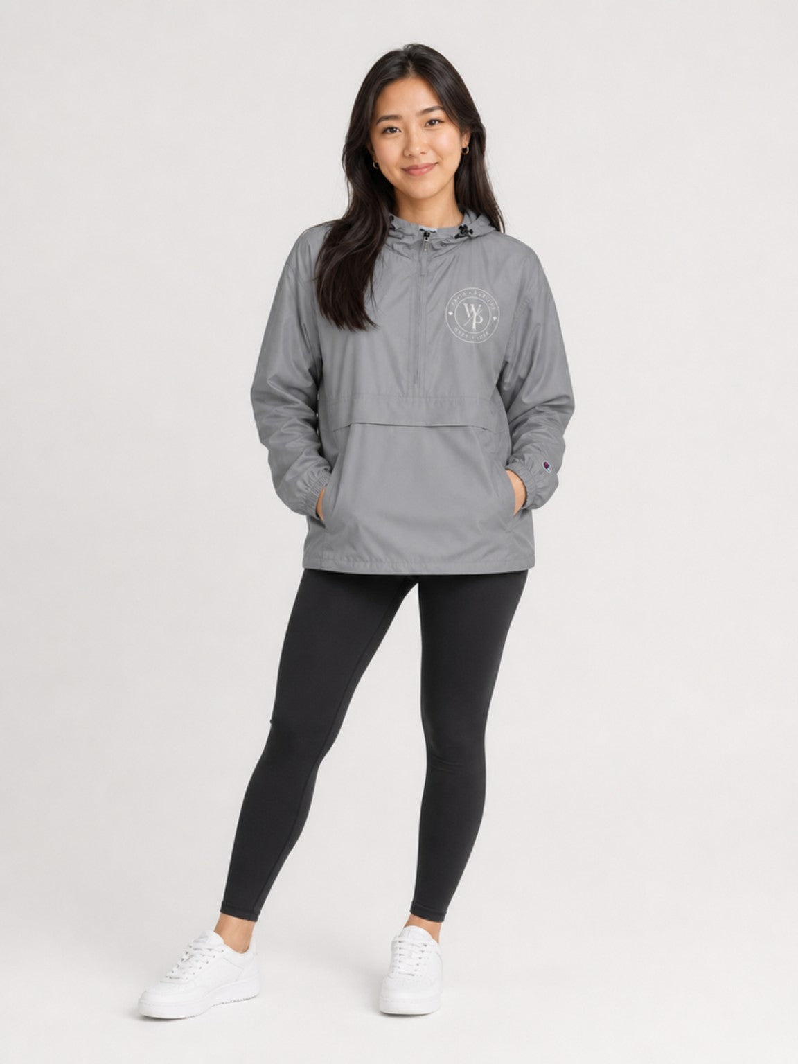 Woman wearing the graphite Worn with Purpose Champion packable anorak jacket, full-body view