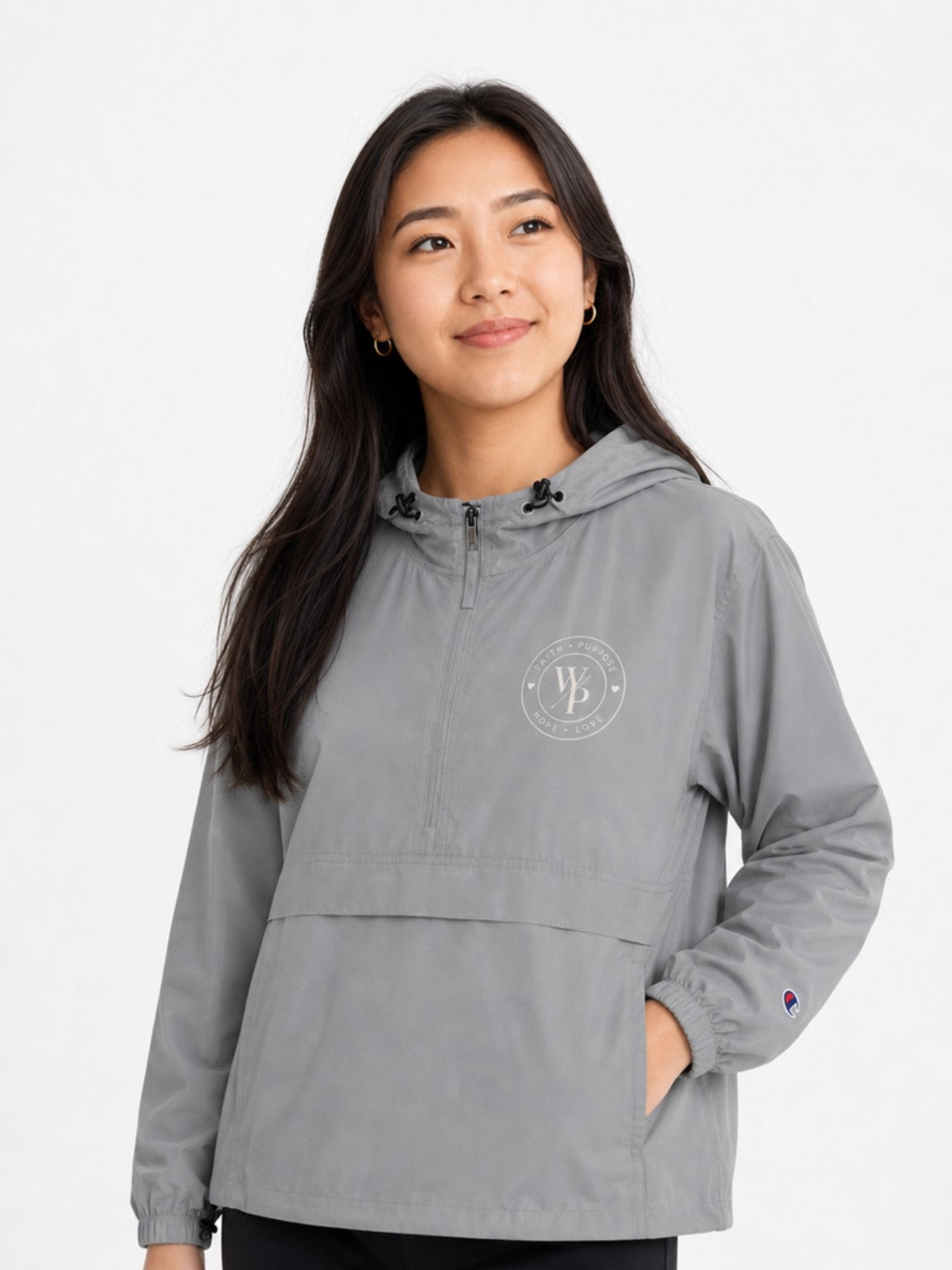 Woman styling the graphite Worn with Purpose Champion packable anorak jacket