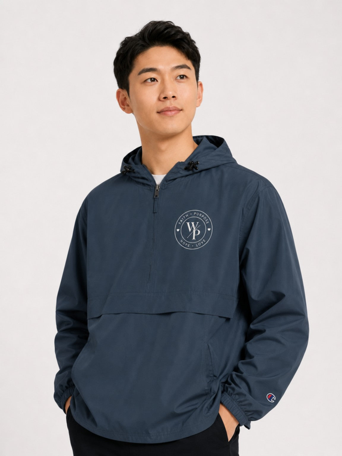 Man styling the navy Worn with Purpose Champion packable anorak jacket